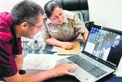 Egon Jose Goudard shows the video on his laptop to the police, in which his maidservant was captured stealing, at the Sector 17 police station in Chandigarh on Friday. 