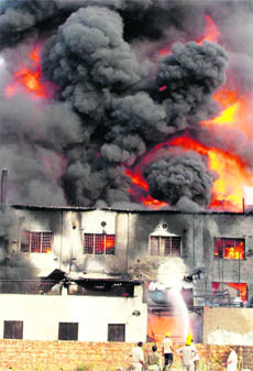 Smoke billows out of Krishna Chemical Factory near Daultabad that caught fire in Gurgaon on Friday.