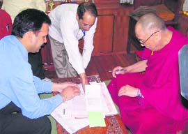 The Dalai Lama providing personal details to census staff at Dharamsala on Friday.