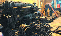 A worker assembles sewing machine parts at an industrial unit in Ludhiana