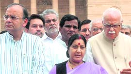 BJP leaders LK Advani, Sushma Swaraj and Arun Jaitley speak to mediapersons in New Delhi on Friday.