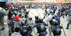 The police attempts to drive away Maoist protesters at Ratna Park in Kathmandu to prevent them from clashing with peace marchers protesting in the same area on Friday.