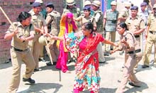 Police personnel lathicharge irate villagers at Bishanpur on Saturday.