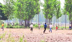 Villagers run to the jungle to escape police action at Bishanpur on Saturday.