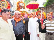 Devotees march in procession on the 15th Foundation Day of Shirdi Sai Temple in Mussoorie on Saturday.