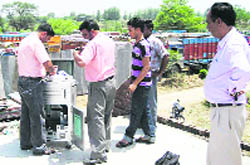Members of the Punjab Pollution Control Board collect samples from the clinker ground at Bikkon village. 