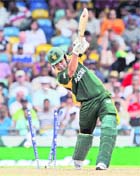 Pakistans Kamran Akmal is clean bowled by New Zealands Kyle Mills in Bridgetown on Saturday.