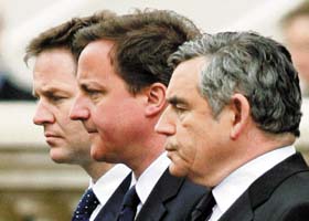 Britain's Prime Minister Gordon Brown (right) stands with Conservative Party leader David Cameron (C) and Liberal Democrat leader Nick Clegg during a Victory in Europe Day ceremony in London