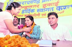 Asha Sharma, head of the womens cell of the Dehradun Mahanagar UKD unit, being felicitated in Dehradun on Sunday.