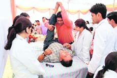 Patients being checked at a health camp organised by the Sai Institute in Dehradun on Sunday.