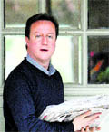 Conservative Party leader David Cameron stands at the doorstep of his house in London on Sunday