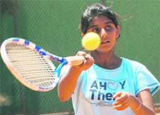 A player in action during a tennis match in Chandigarh on Monday. 