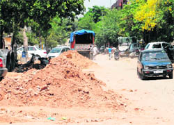 A view of the damaged road in the Industrial Area, Phase I, reportedly due to the plying of heavy earth moving machinery of a construction company at the site of a mega mall.