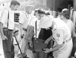 The police checks bag of a passenger at the Mohali railway station on Monday.