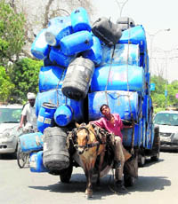 A rehra overloaded with drums in Amritsar on Monday