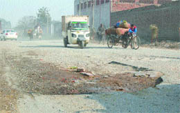 Roads teeming with potholes like this are a bane for commuters in Amritar