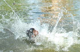 SPLASH: A child jumps into a pond as the mercury rises in New Delhi
