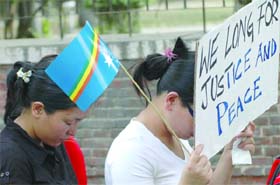 Women activists of the Naga Students Union Delhi (NSUD) hold placards during a protest march to demand peace and justice for their state at Jantar Mantar in New Delhi
