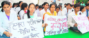 Students of Swami Narayan Medical College stage a demonstration in Dehradun on Tuesday.