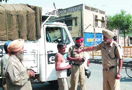 A police official instructs a van driver to park his vehicle properly.