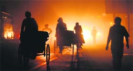 A view of people caught in the dust storm and rain that lashed Ludhiana on Monday night.