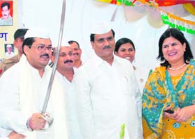 Union Minister for Social Justice Mukul Wasnik raises a sword at a Congress Sewa Dal camp in Chandigarh