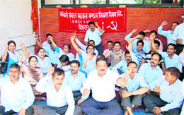 Employees of the Garhwal Mandal Vikas Nigam hold a dharna in Dehradun on Wednesday