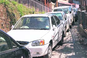 Tourist vehicles parked at a link road blocking traffic in Mussoorie