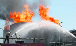A fireman tries to douse the fire at NV Distilleries in Ambal