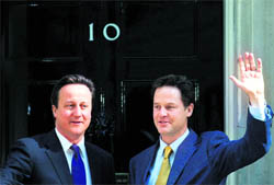 Britain's Prime Minister David Cameron (left) and Deputy Prime Minister Nick Clegg pose at 10 Downing Street in London on Wednesday. -