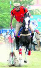 A horse rider displays his skills during the Khalsai Games at Baba Banda Singh Bahadur Engineering College, Fatehgarh Sahib, on Thursday