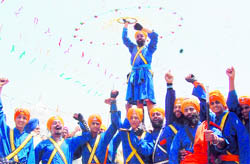 Nihangs perform gatka during Fateh March in Mohali on Thursday
