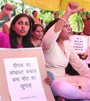 Members of Delhi University Teachers Association hold a protest in New Delhi on Thursday.