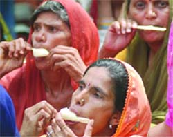Women take an ice cream break as the maximum temperature goes up to 44 degrees Celsius in New Delhi on Thursday.