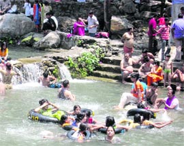 As temperature crosses the 40 C, a large number of people flocked to Sahastradhara to have a splash.