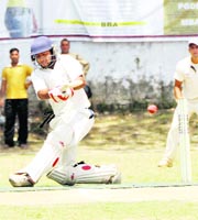   A batsman plays a shot at the All-India Gold Cup Cricket Tournament in Dehradun on Thursday. 