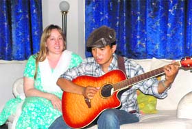 Lisa with a member of the Himalayan Band formed by locals at Dharamsala