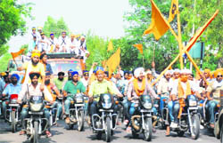 Youths on motor cycles take part in the Fateh March as it crosses Chunni village and heads for Fatehgarh Sahib