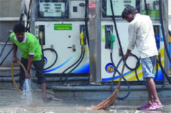 Petrol pump workers utilise their time while observing a one-day strike in New Delhi on Friday.