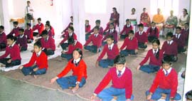 Students being taught yoga at the Radhakrishan Temple in Kulri on Friday