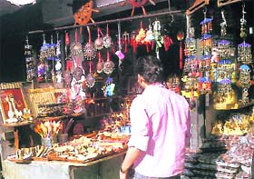 A customer looks at various articles displayed in shops at Kufri