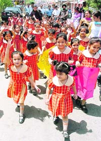 Students of Rich Harvest Kindergarten School take part in a save the girl child awareness rally in Jammu