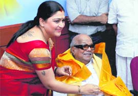 Tamil film actress Khushboo presenting a shawl to Tamil Nadu Chief Minister M Karunanidhi after joining DMK in Chennai on Friday.