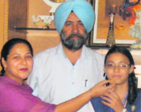 Celebration time: Haramanjit being offered sweets by her parents in Sirhind