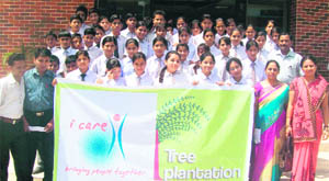 Students participate in a tree plantation drive organised by the Doon Hills Academy and I-Care in Dehradun on Saturday. 