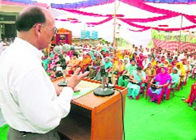IPH Minister Ravinder Ravi addressing a public meeting at Pragpur