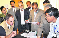 Chief Minister Omar Abdullah fills up the data collection form at his residence in Srinagar on Saturday.