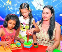 Gurpreet Sekhon helps out kids at Jelly Bean Junction.