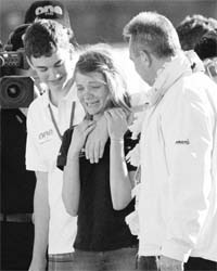 Sixteen-year-old Jessica Watson (centre) is greeted by her brother Tom (left) and her father Roger upon her arrival at a dock in Sydney