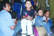 An affected family waits at the platform
